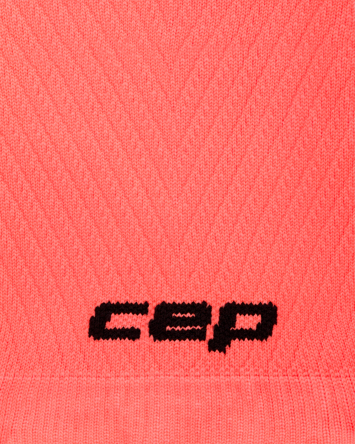 Core Run Ultralight Compression Arm Sleeves, Neon Coral, close-up detail